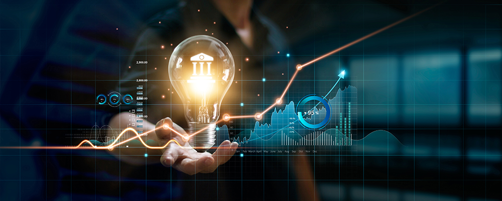 Businessman holding creative light bulb with growth graph and banking icons. Financial innovation technology develop new products and services that enhance successful and profit in global business.